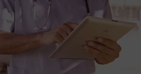 Clinician Using Tablet Technology in Hospital Environment