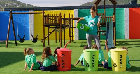Teacher Teaching Children Recycling in School Playground Environment