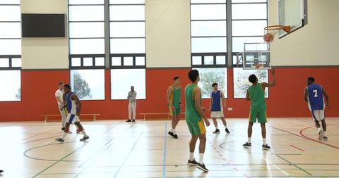 Energetic Basketball Game in Bright Indoor Gymnasium