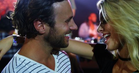 Happy Young Couple Bonding at Party