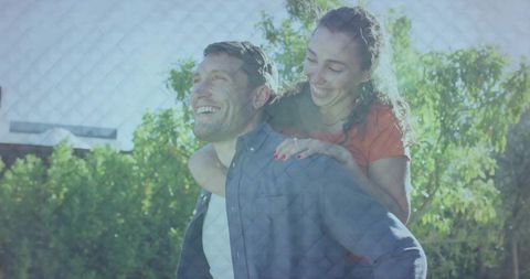 Happy Couple in Sunny Backyard Embracing Each Other