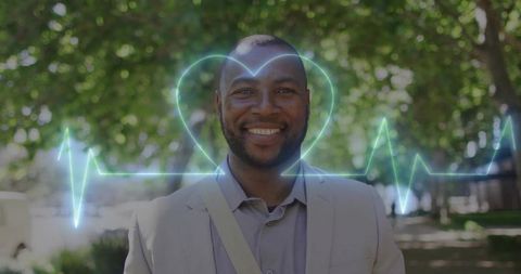 Smiling professional man walking sunlit urban park path with neon heartbeat overlay, wellness concep