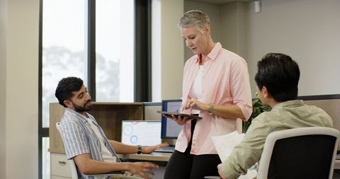 Diverse Team Collaborating in Modern Office Environment with Technology