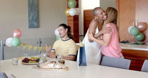 Joyful Home Gathering with Friends Hugging and Chatting