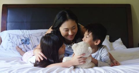 Asian Mother Enjoying Family Time with Loving Children - Download Free Stock Images Pikwizard.com