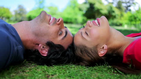 Couple Relaxing on Sunny Grass in Countryside