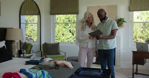 Couple Planning Wedding Using Tablet in Bright Living Room