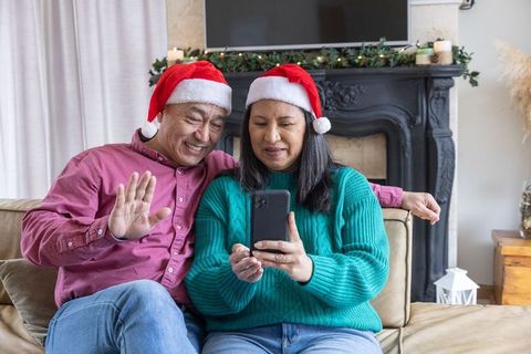 Festive Couple Video Calling in Santa Hats, Celebratory Scene