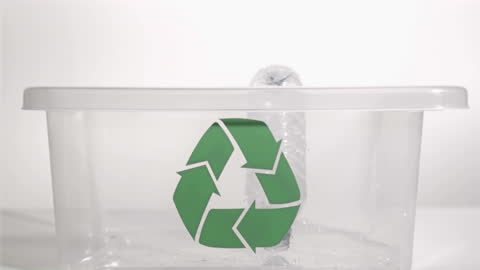 Plastic Bottle Dropping into Recycle Bin