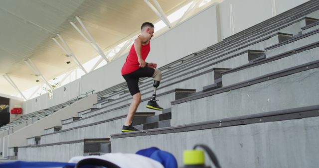 Amputee athlete training hard running up stadium stairs - Download Free Stock Images Pikwizard.com