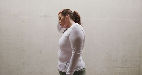 Tired Plus Size Woman in Workout Gear Resting Against Wall - Download Free Stock Images Pikwizard.com