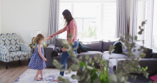 Mother and Daughter Dancing in Bright Living Room - Download Free Stock Images Pikwizard.com