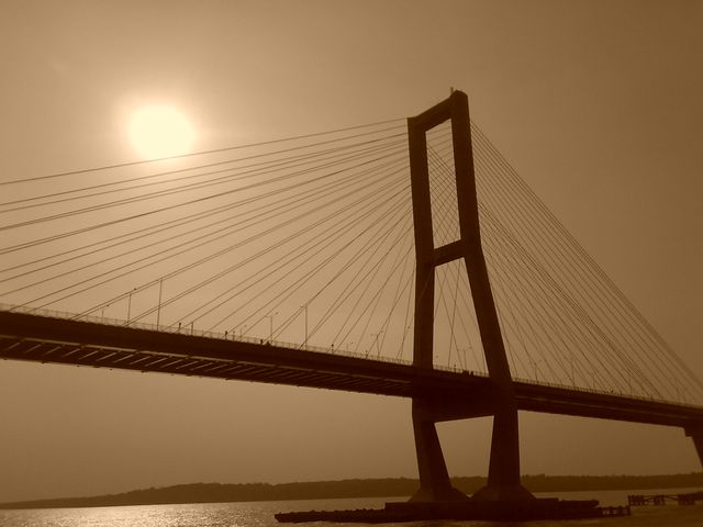 Suspension Bridge Against Sunlit Sky in Sepia Tone - Download Free Stock Photos Pikwizard.com