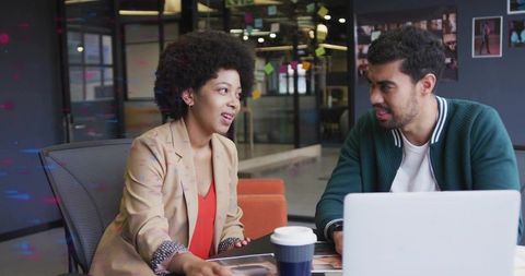 Colleagues Engaged in Creative Brainstorming Session in Modern Office
