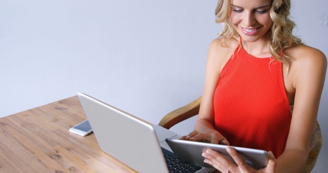 Smiling Woman Using Tablet and Laptop at Desk - Download Free Stock Images Pikwizard.com