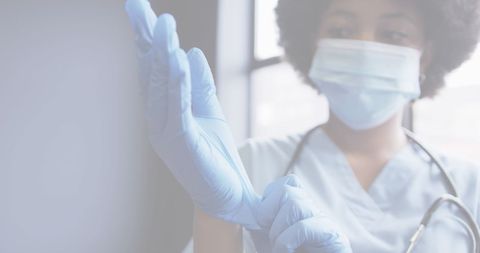 healthcare professional with mask and gloves in medical setting - Download Free Stock Images Pikwizard.com