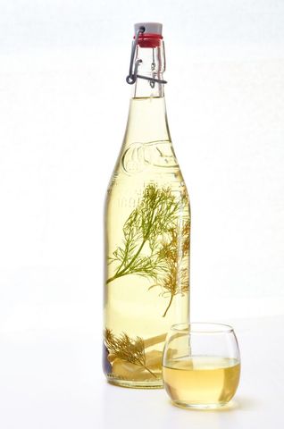 Traditional herbal liquor in bottle with glass