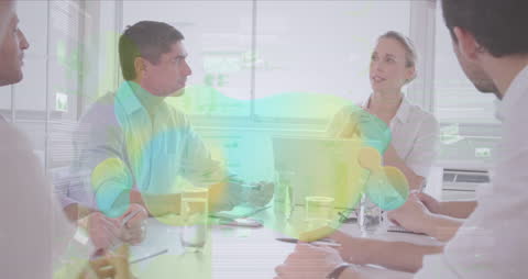 Business Team Engaged in Discussions with Abstract Overlay