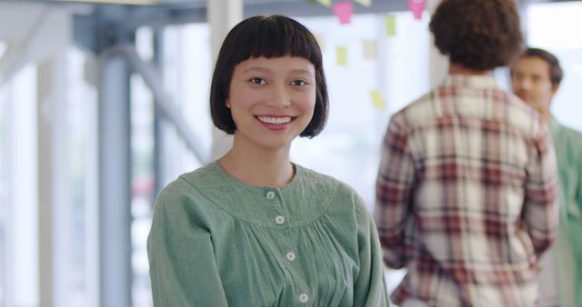 Young Professional Woman Smiling in Collaborative Office Environment - Download Free Stock Images Pikwizard.com