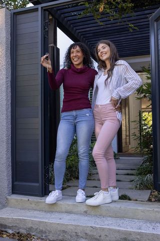 Joyful Moment of Female Homeownership in Modern Entryway