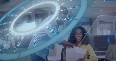 Smiling coworkers collaborating with augmented reality data overlays in modern office
