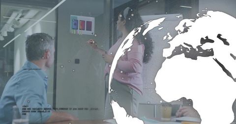 Pointing presenter sketching on glass wall with color swatches and global digital overlay