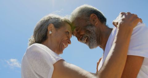Happy Senior African American Couple Embracing Under Clear Blue Sky - Download Free Stock Images Pikwizard.com
