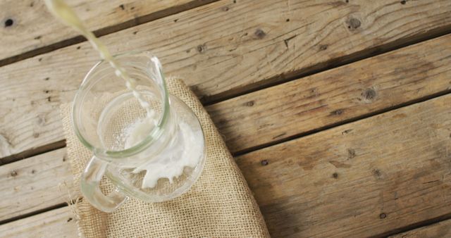 Pouring Milk into Rustic Glass Pitcher on Wooden Surface - Download Free Stock Images Pikwizard.com