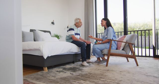 Image of biracial female doctor giving pills to caucasian senior man. seniors health and nursing home lifestyle concept digitally generated image.