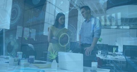 Office Team Analyzing Digital Data Graphics on Laptop