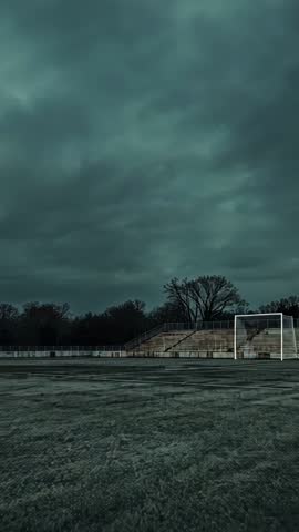 Drifting Clouds Over Frost-covered Soccer Pitch at Dawn - Vertical Video