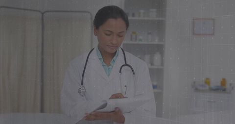 Female Doctor Writing Notes in Clinic Office with Clipboard