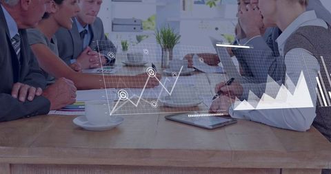 Business Team Collaborating Over Tablet While Reviewing Overlaid Growth Charts and Analytics