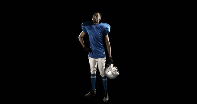 Confident American Football Player in Blue Uniform Standing with Helmet - Download Free Stock Images Pikwizard.com