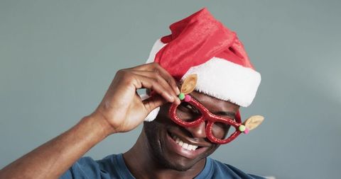 Cheerful Celebration with Festive Reindeer Glasses and Santa Hat