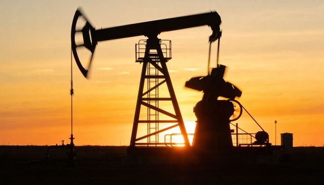 Pumpjack silhouette pumping at golden sunset on open plain for industrial energy visuals