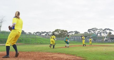 Female softball players engaging in game with dynamic team play