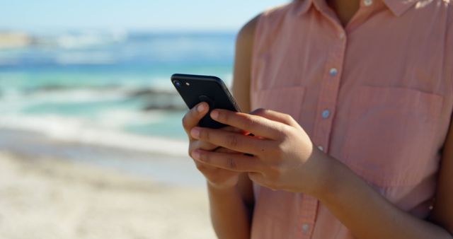 Woman Texting on Smartphone by Ocean Shore on Sunny Day - Download Free Stock Images Pikwizard.com