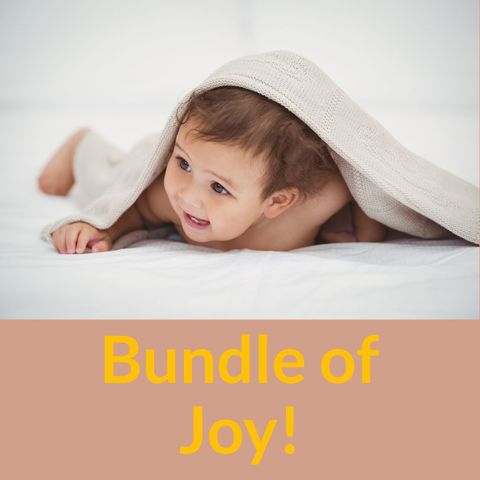 Adorable baby smiling under blanket concept
