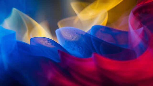 Glowing petal-like folds reflecting colored gels and water droplets, macro abstraction