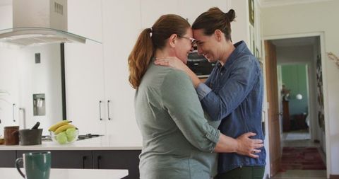 Lesbian Couple Bonding in Bright Modern Kitchen