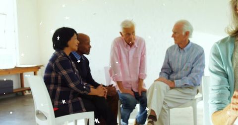 Older adults engaging in relaxed group discussion in bright community space