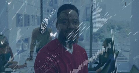 Smiling Professional with Financial Data Visualization in Office