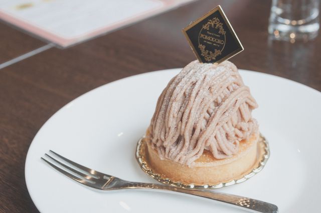 Mont Blanc dessert presented on white plate with a fork, highlighting its intricate design and rich flavor. Ideal for use in food blogs, restaurant promotions, culinary magazines, bakery advertisements, and gourmet recipe websites.