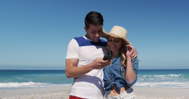 Happy Couple Enjoying Beach Time Checking Smartphone - Download Free Stock Images Pikwizard.com