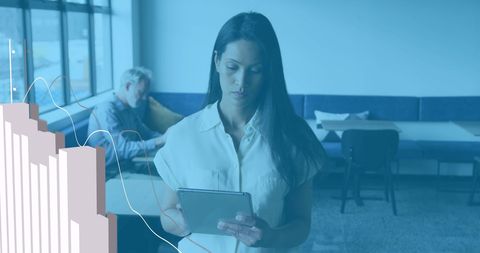 Modern businesswoman analyzing data on digital tablet in office