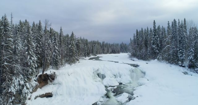 Aerial View of Snow Covered River and Frozen Waterfall in Winter Forest - Download Free Stock Images Pikwizard.com