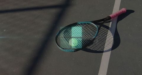 Tennis equipment on court highlighting outdoor sports