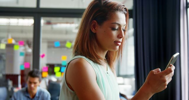 Young Businesswoman Using Smartphone in Modern Office - Download Free Stock Images Pikwizard.com