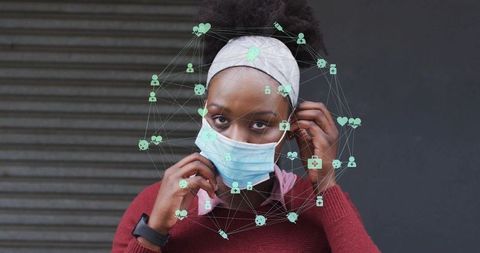 Adjusting surgical mask on street woman wearing smartwatch with digital health overlay